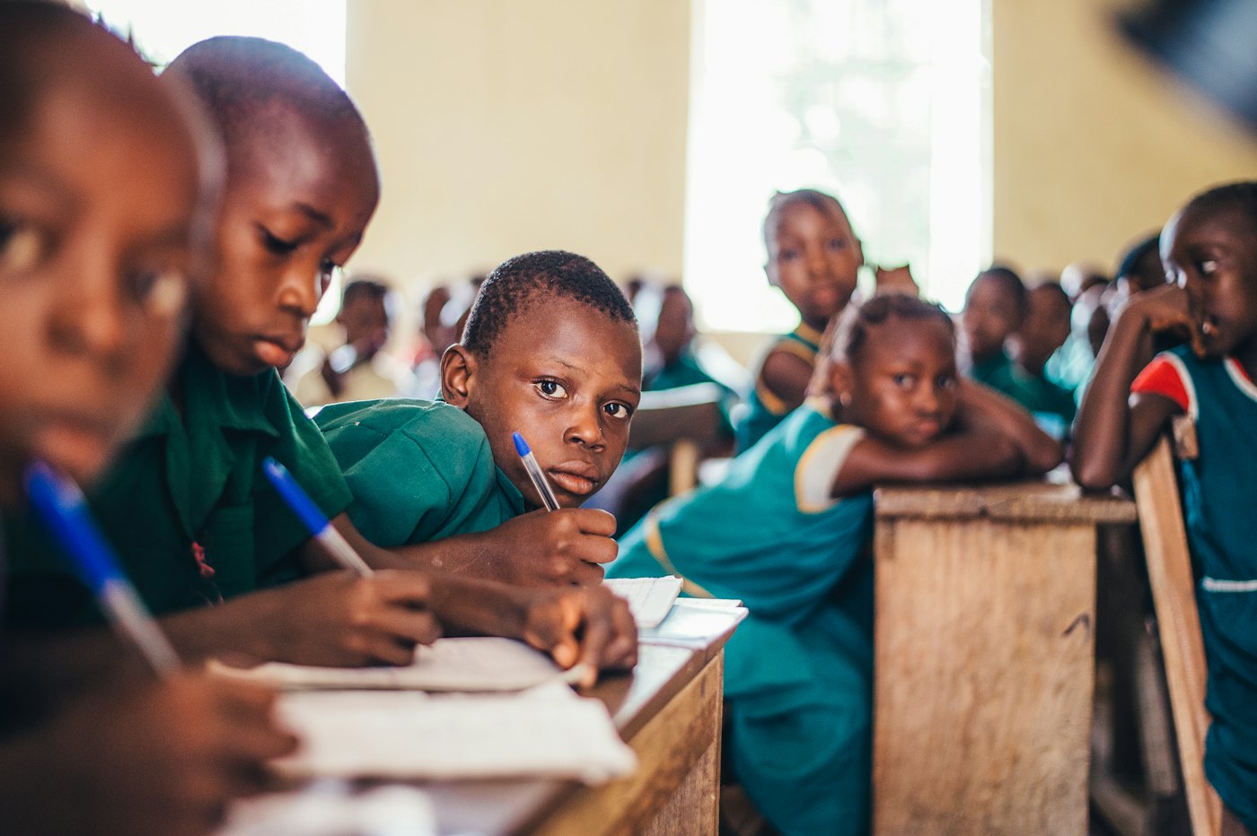 Children writing in exercise books